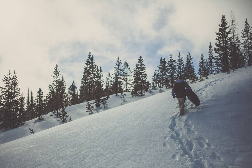 A person walking up a snowy slope