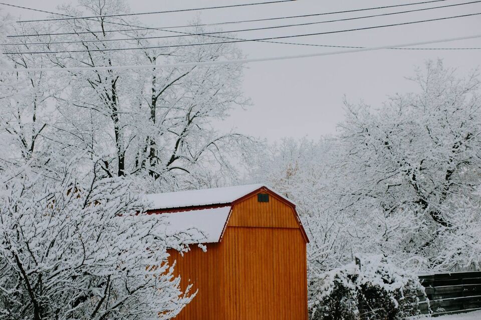 A red barn in hoarfrost and snow